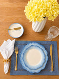 Morning Sky table setting with blue placemat, white linen napkin, gold napkin ring, and blue plate