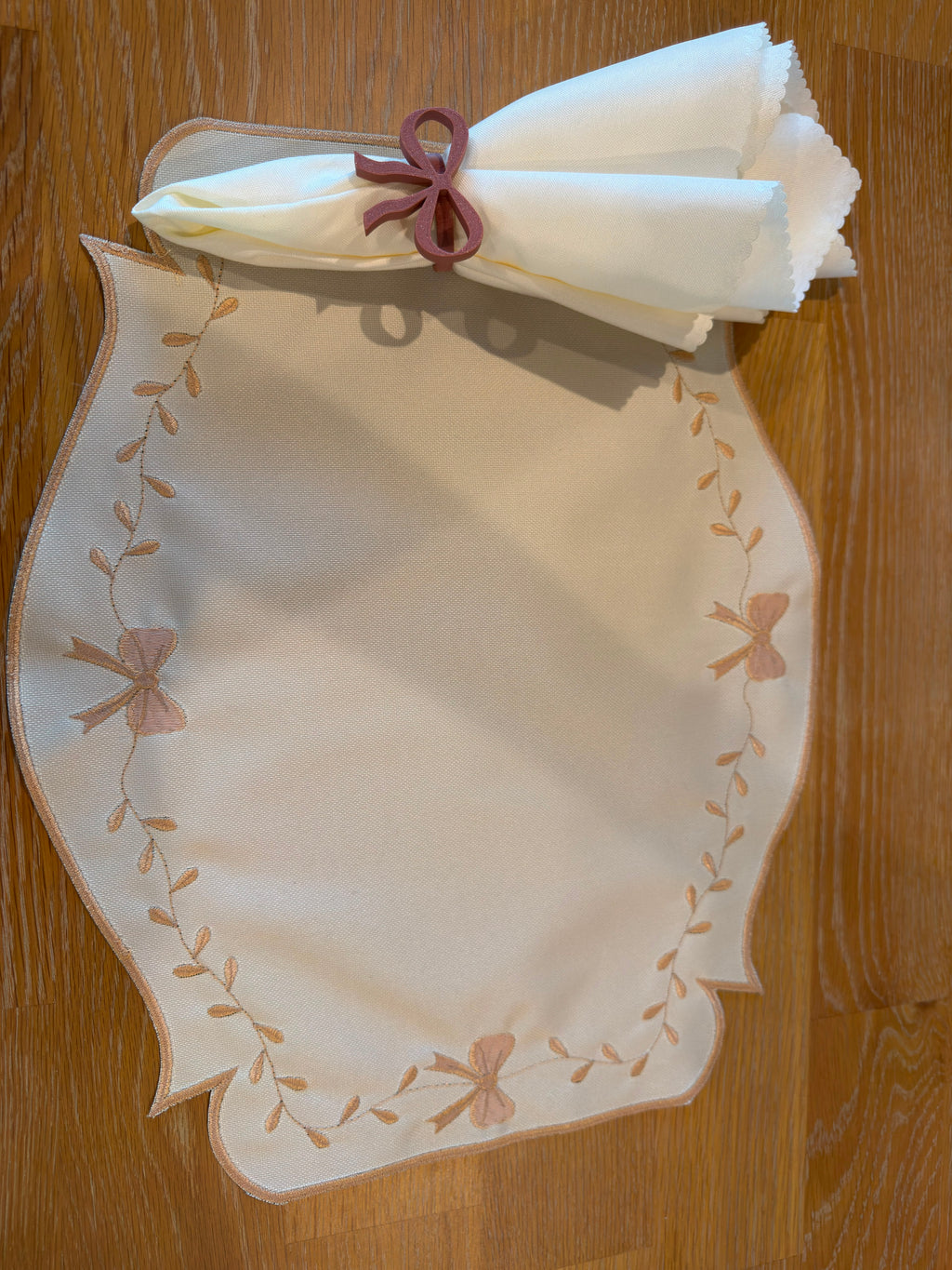 Ivory Grace reversible placemat, beige side with matching bow embroidery