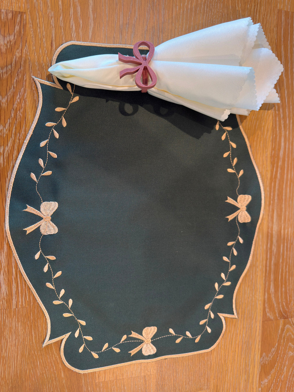 Ivory Grace reversible placemat, green side with beige bow embroidery