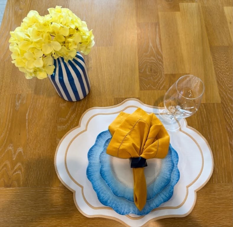 Soleil Bleu reversible placemat, ivory side with gold trim, mustard napkin