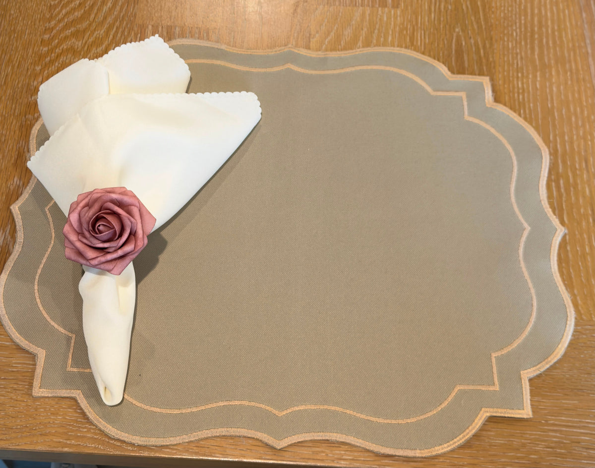 Countryside Charm table setting with gingham placemat, cream napkin, and dusty rose flower napkin ring