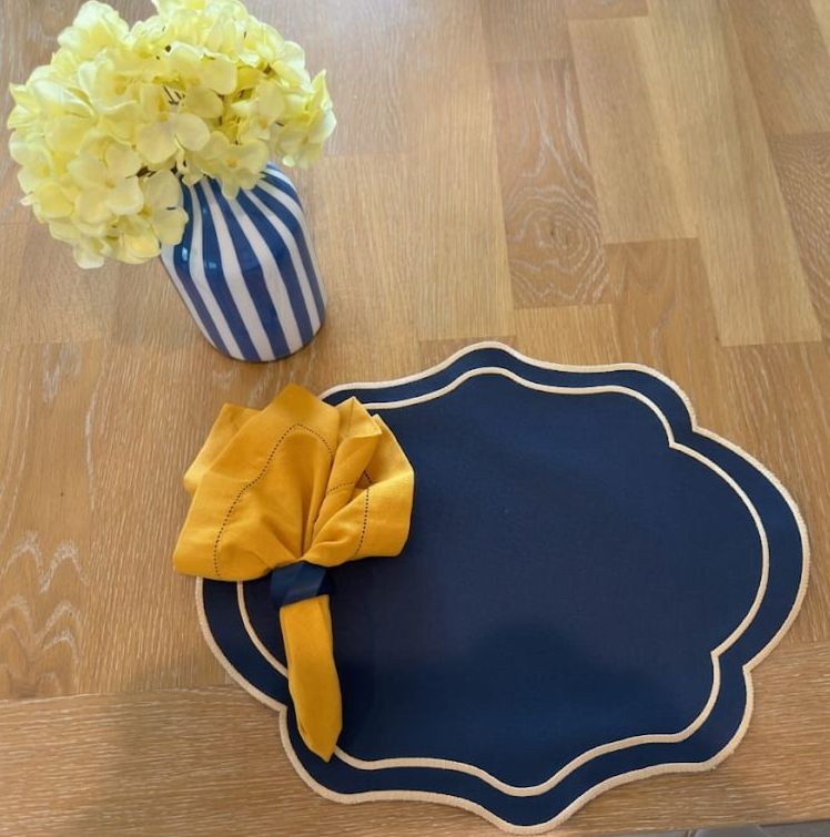 Soleil Bleu navy placemat with mustard linen napkin and navy napkin ring